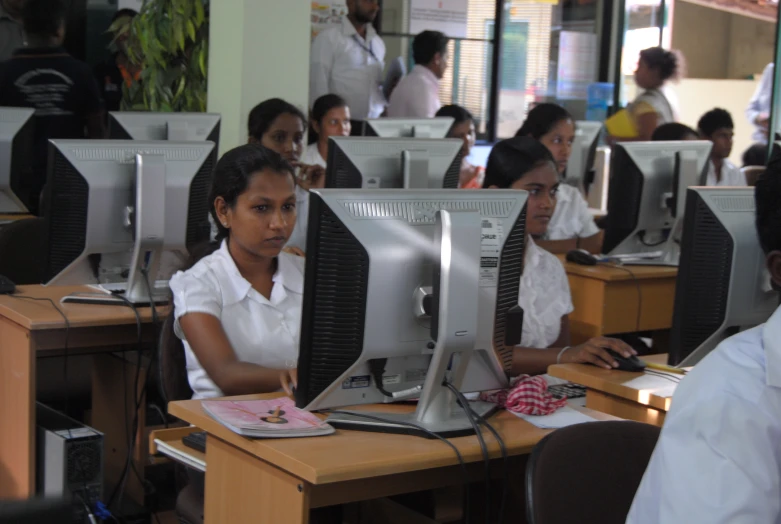 several people working on computer equipment in a class