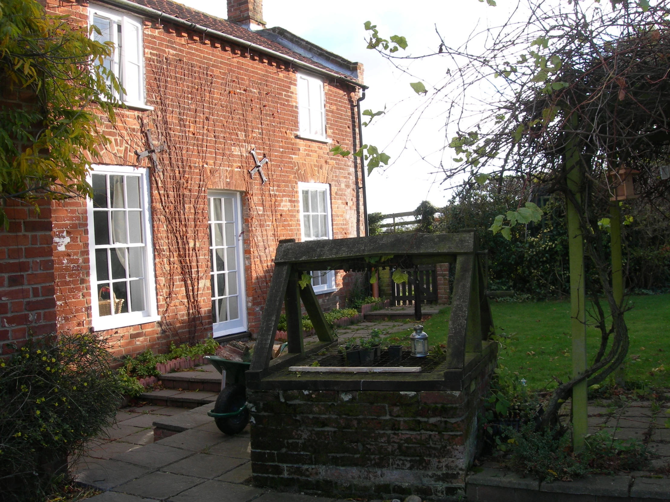 an outdoor garden area with brick building and stone steps