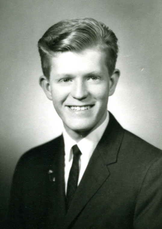 an old pograph shows a young man in a suit and tie