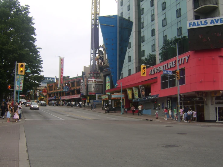 a city street with people walking by buildings and signs