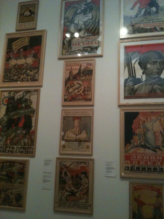 several different posters mounted to the wall in a room
