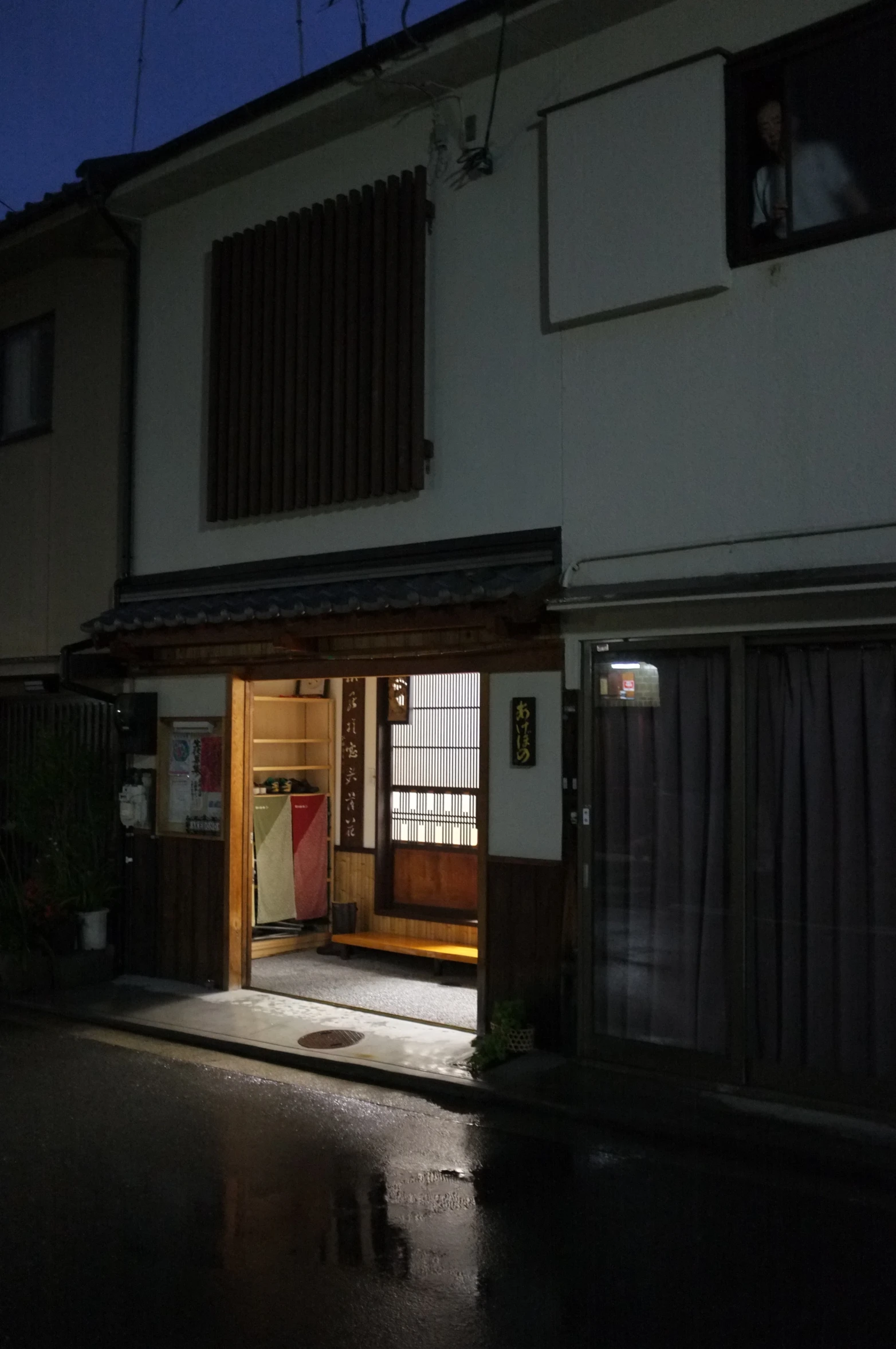 an apartment complex at night with the dark outside