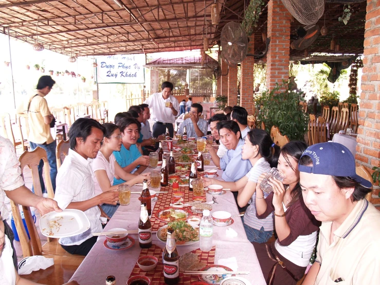 people are sitting down for a long table