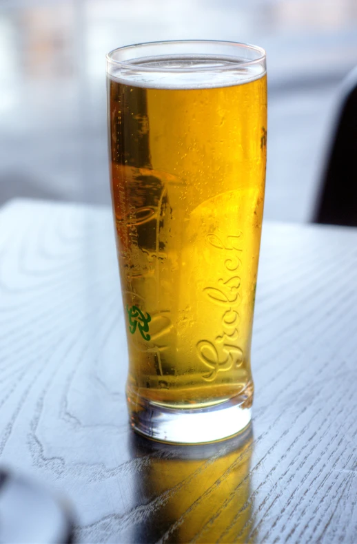 a cold drink is sitting on a wooden table