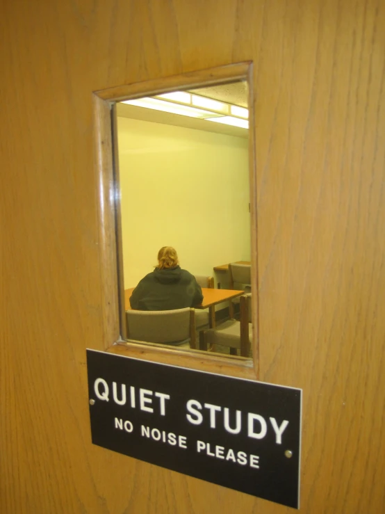 the reflection of an office building's employee in the door