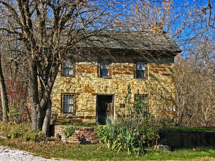 an old abandoned house sits in a field