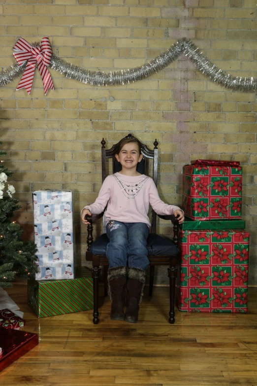 the little girl is posing with her presents