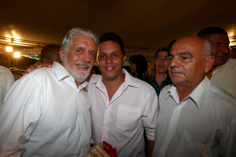 three men with gray hair smile together