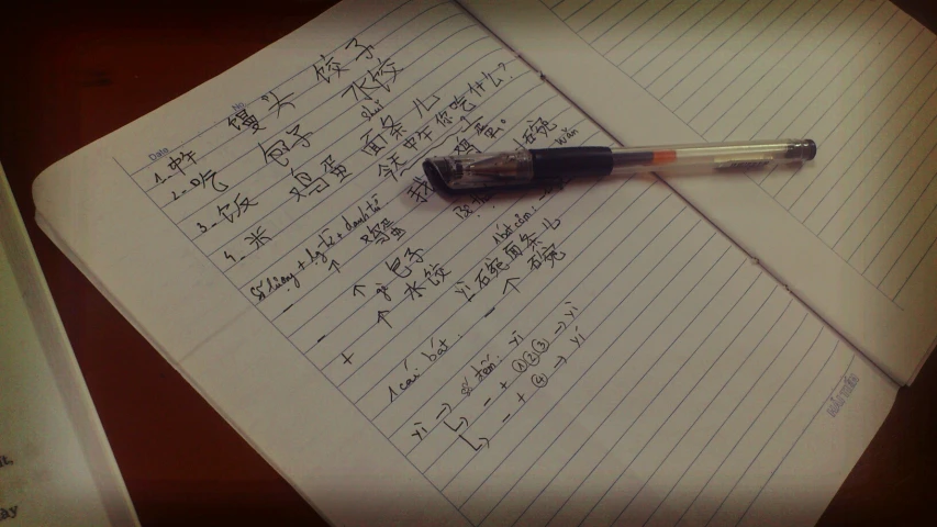 an opened notebook containing various calculations and writing