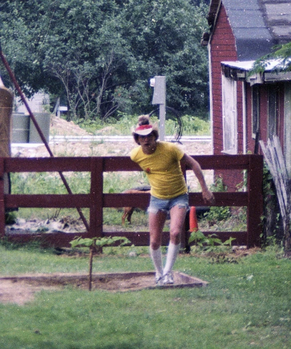 an older person is playing baseball by a fence