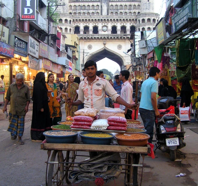 a man standing at a food vendor selling food