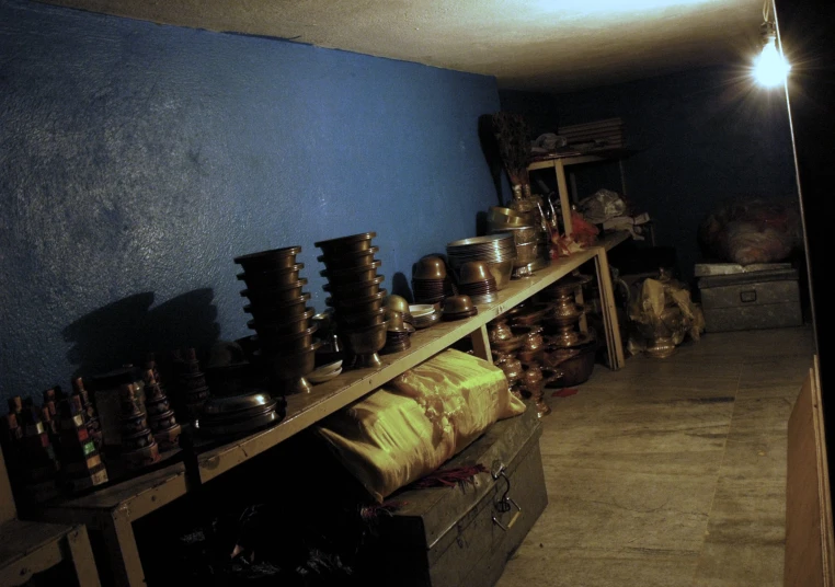 a collection of decorative items and vases on a shelf