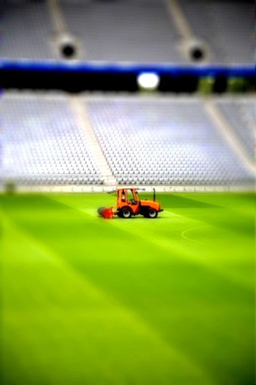 a tractor parked on top of a soccer field