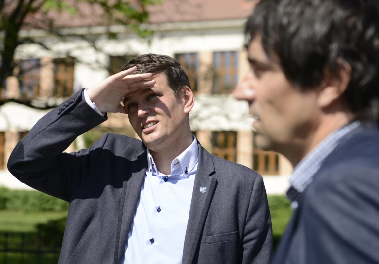 a man saluting to another man in front of him