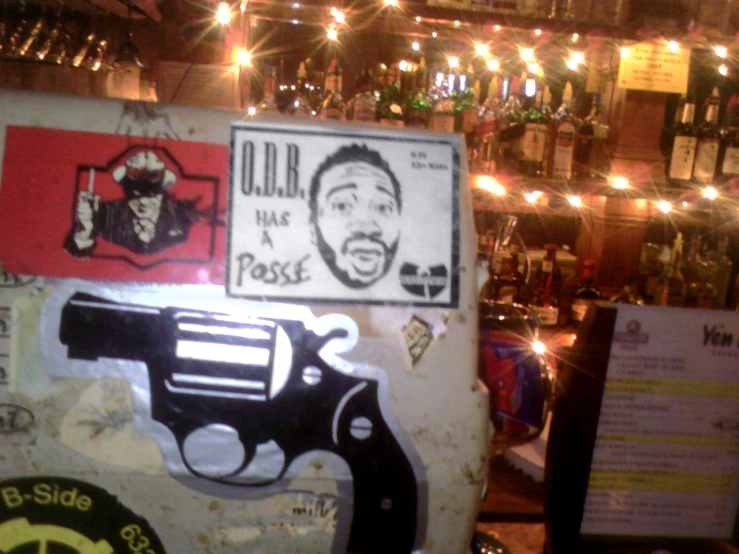 a bar with posters and signs on the wall