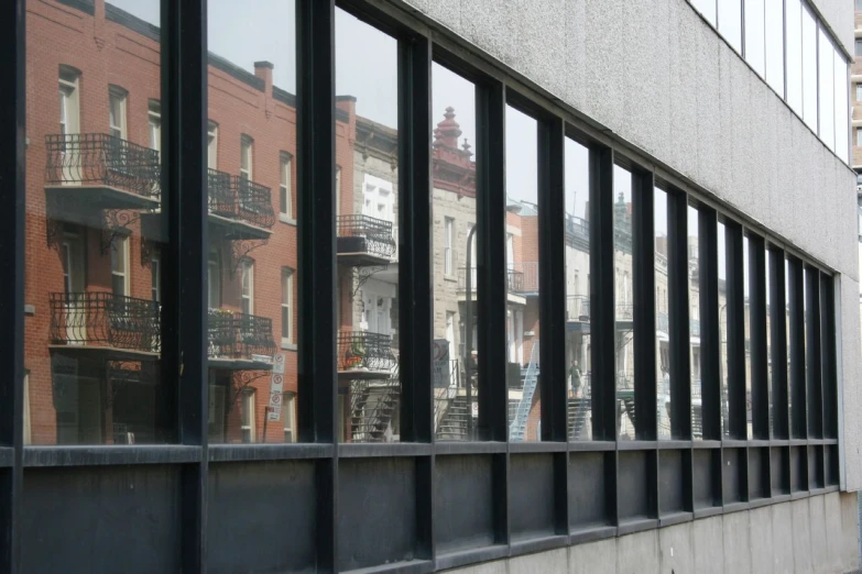 city buildings seen through the windows of a modern building