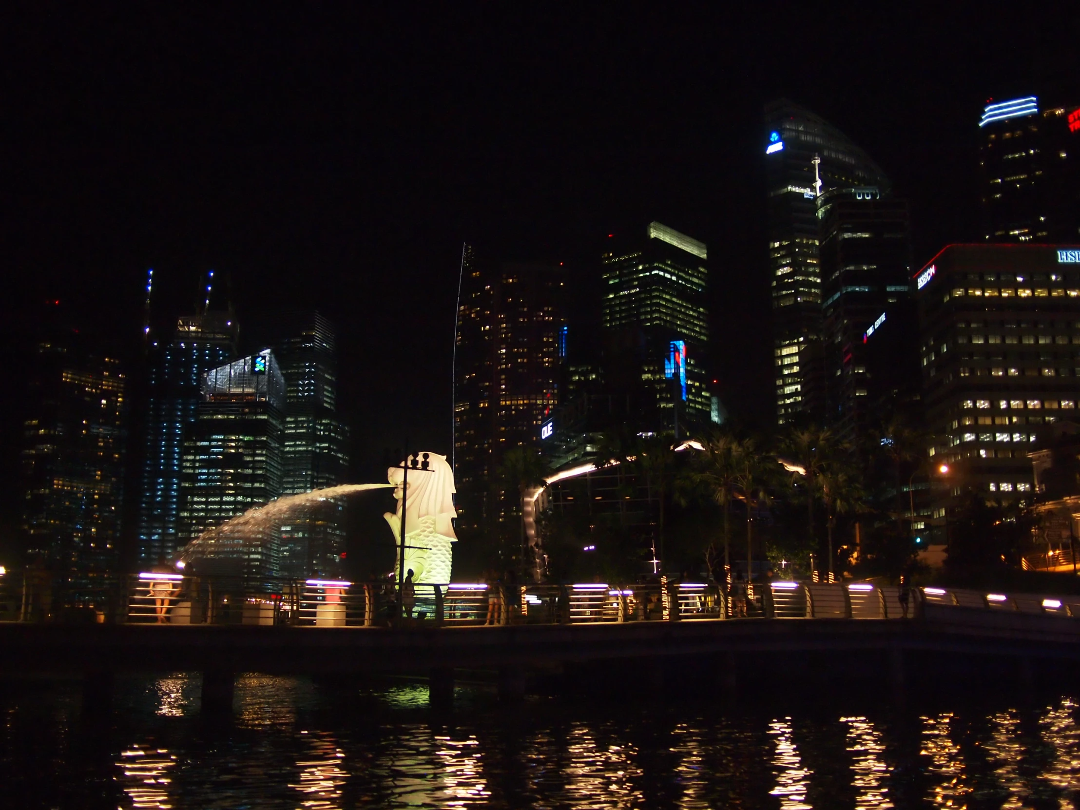 a skyline in the city of singapore is lit up with neon lights