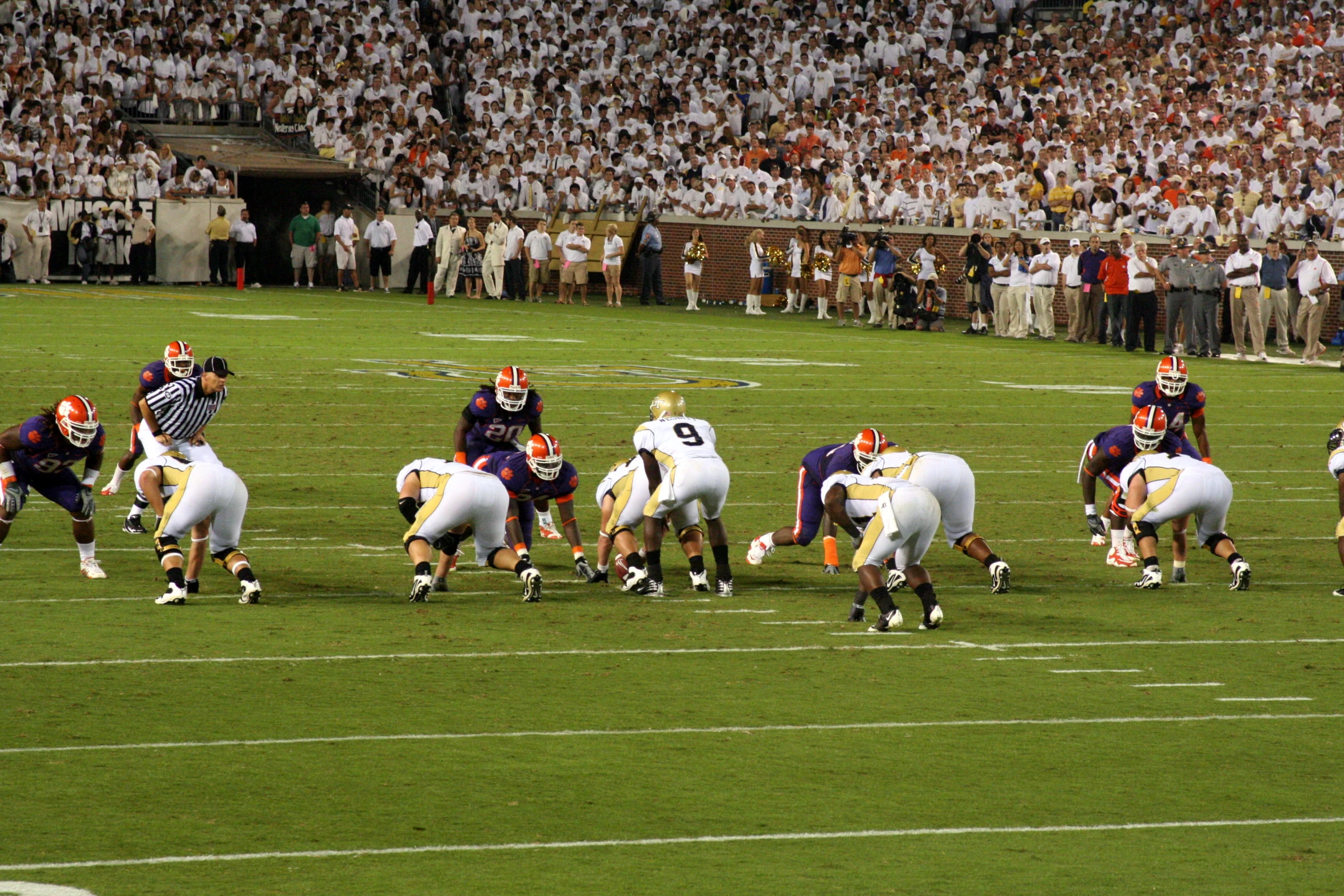 a football game in progress with many people watching