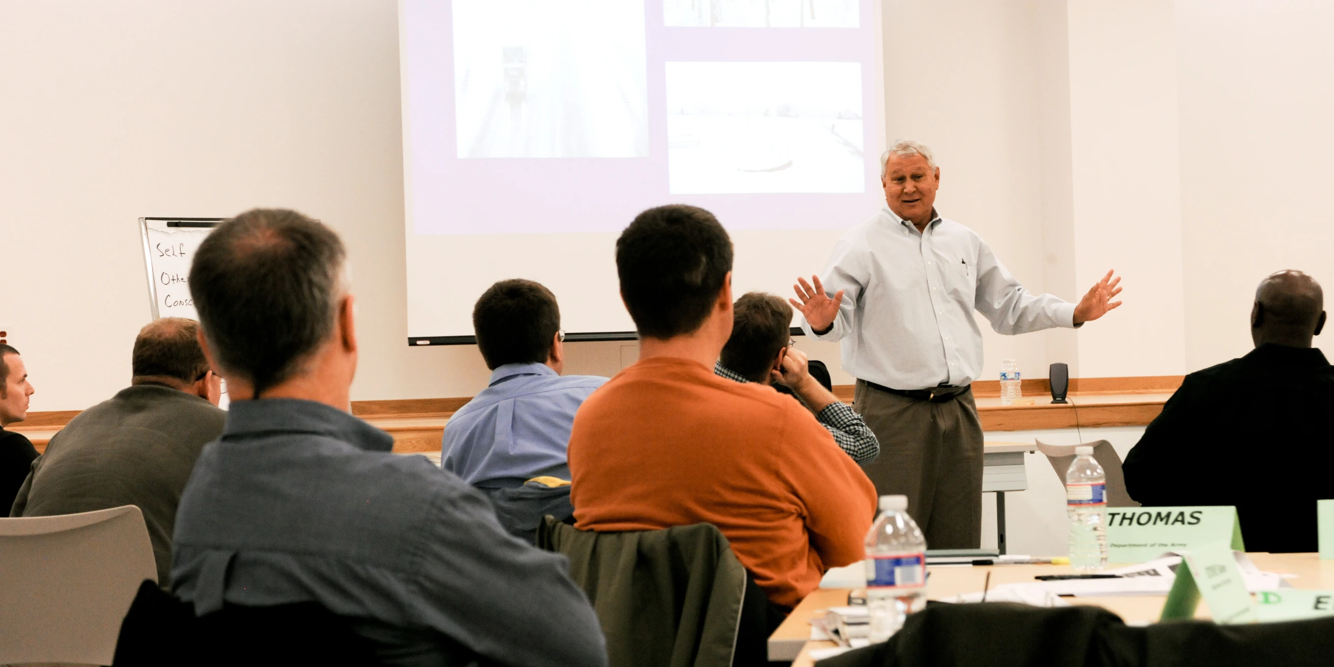 a man giving a presentation at an indoor event