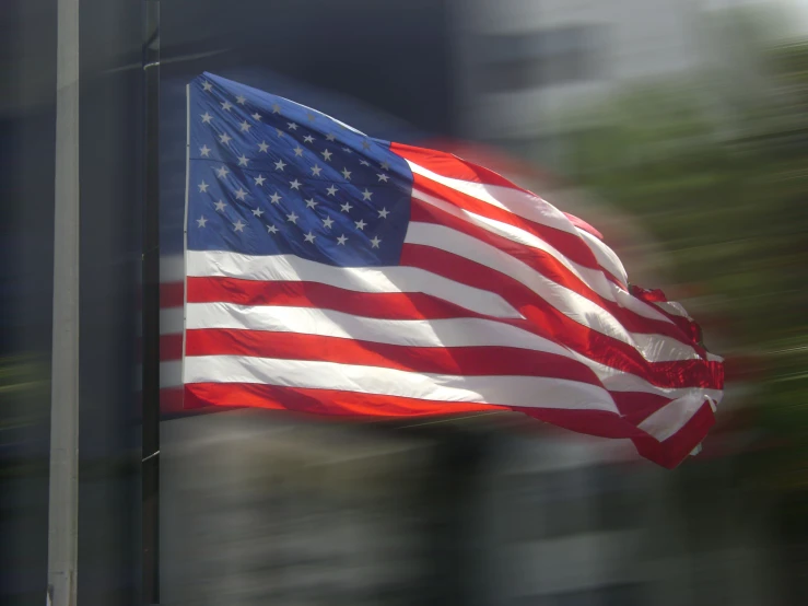 the american flag is reflected in the window