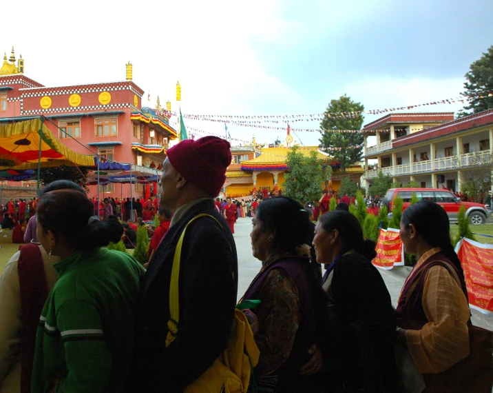 group of people outside in front of buildings