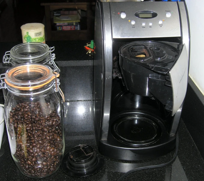 two jars containing beans near the coffee maker
