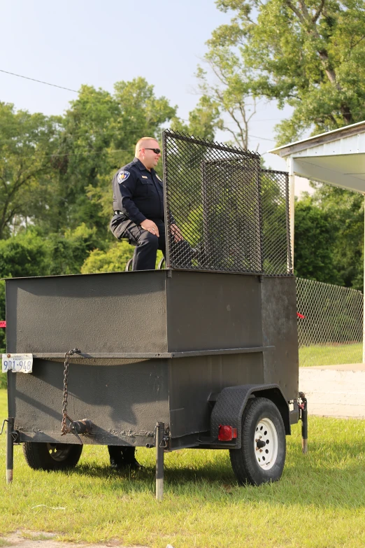 a police officer stands behind a metal box