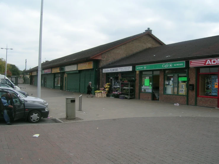 the small car is parked in front of a business