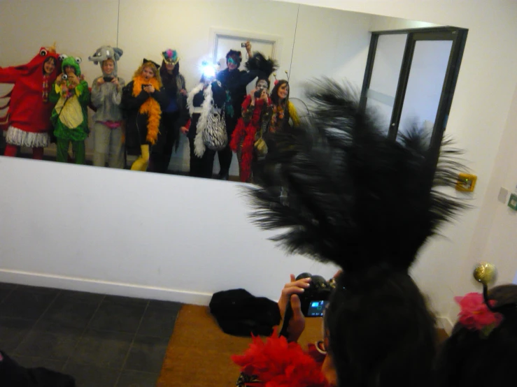 a bunch of people with costume and hair in a room