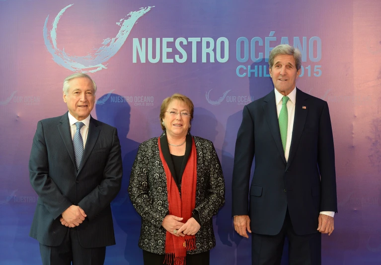 a couple of people in suits and ties posing for a picture