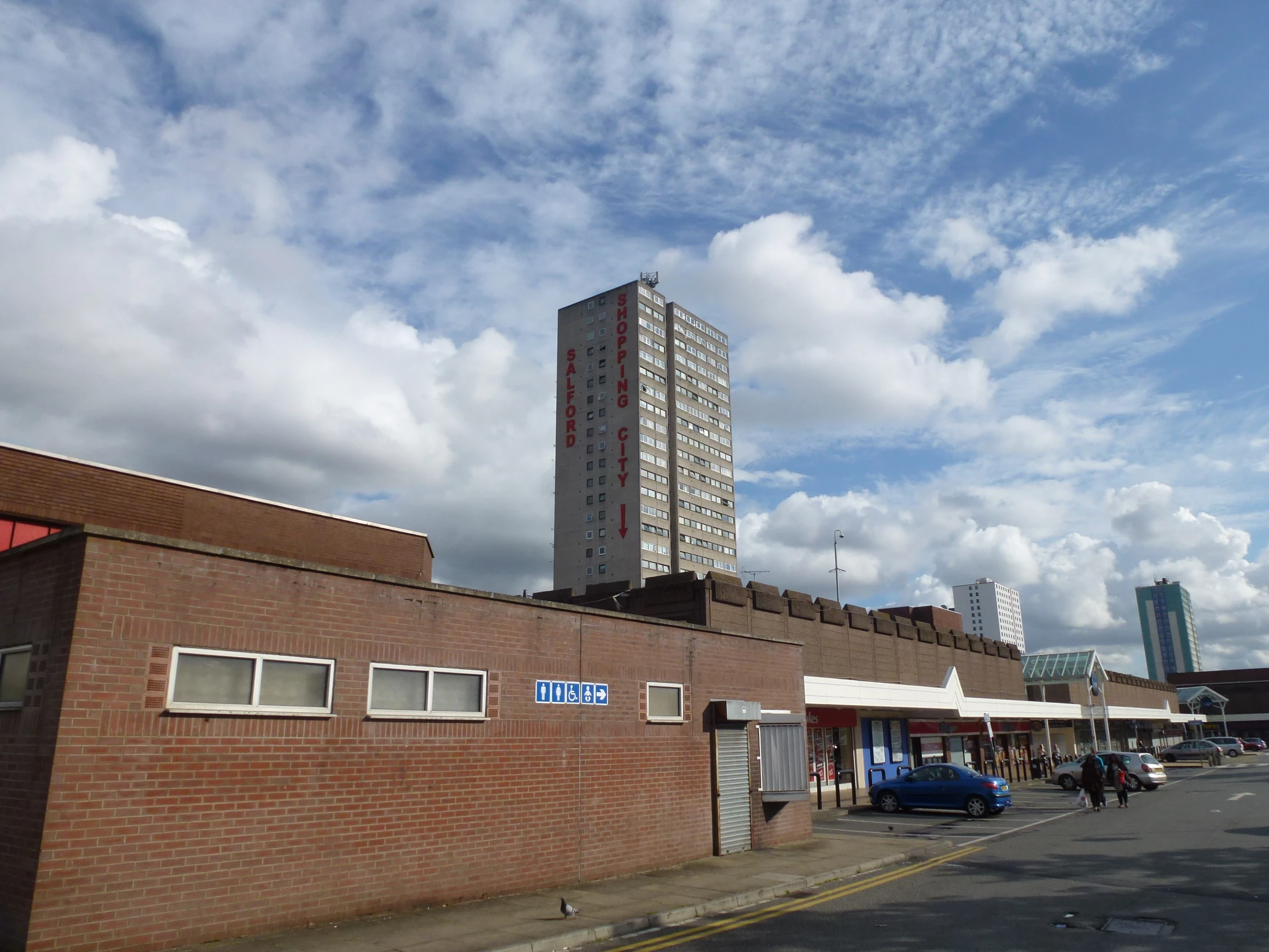 a tall brick building next to a road