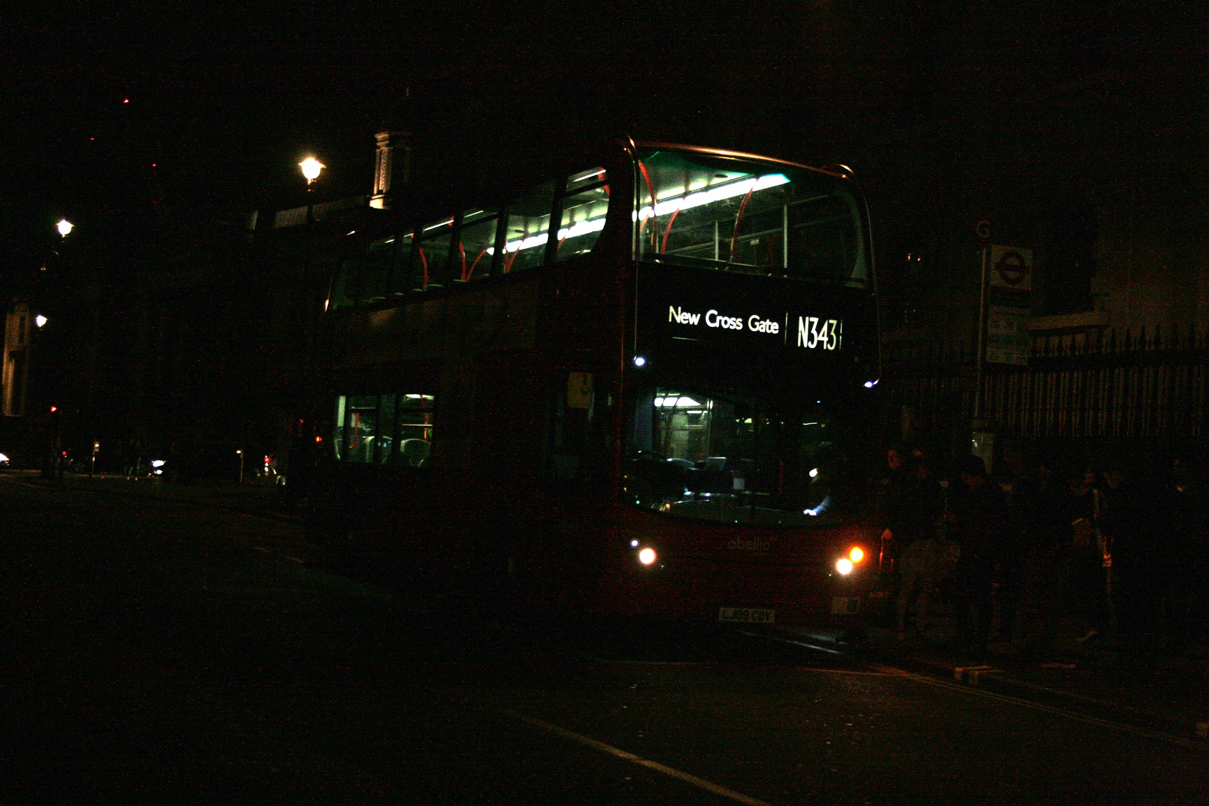 double decked bus on street at night with lights