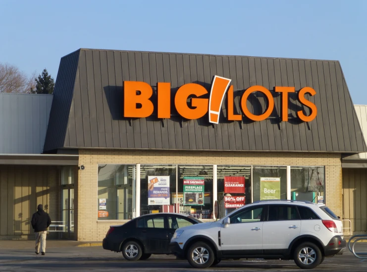 a big lots store with one car and a man walking into the door