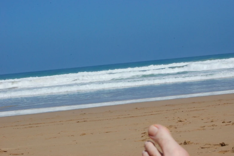 an object that is laying in the sand near the water