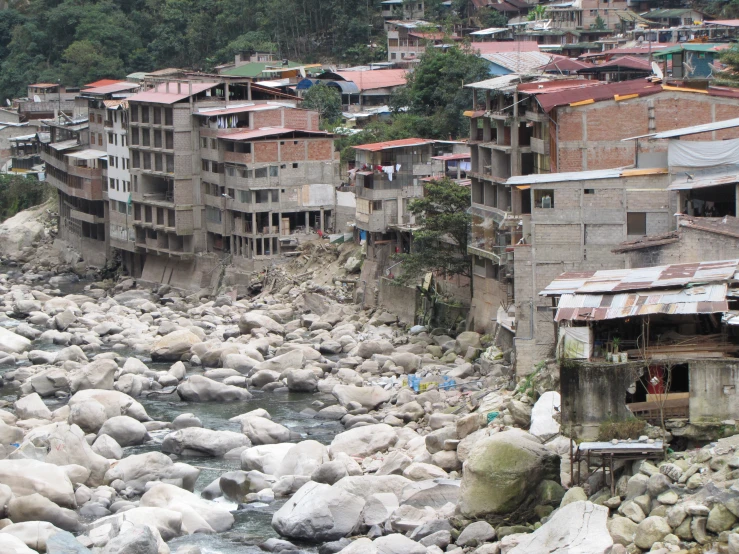 several people walking over the edge of a river