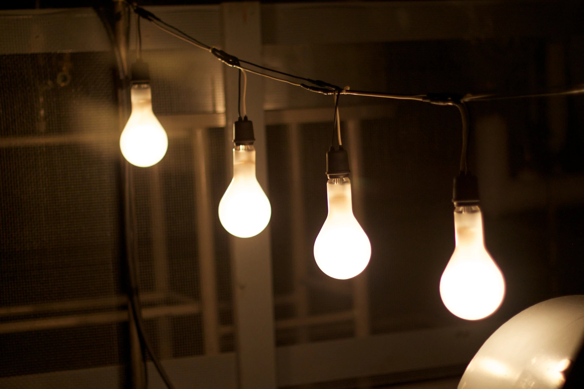 a bunch of lights with bulbs on top of a string