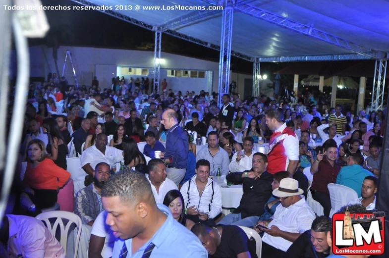 a large crowd of people that are sitting in chairs