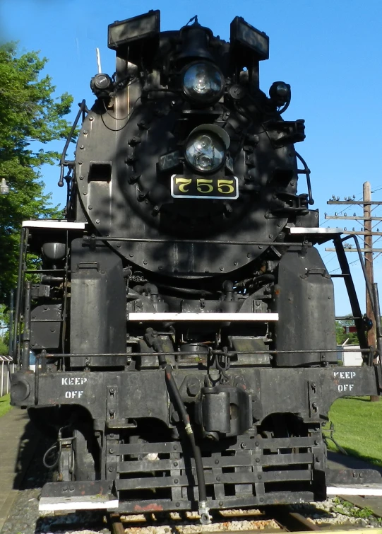 a black steam locomotive sitting on tracks in a park