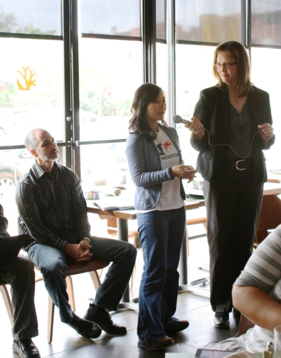 several people that are standing around a table