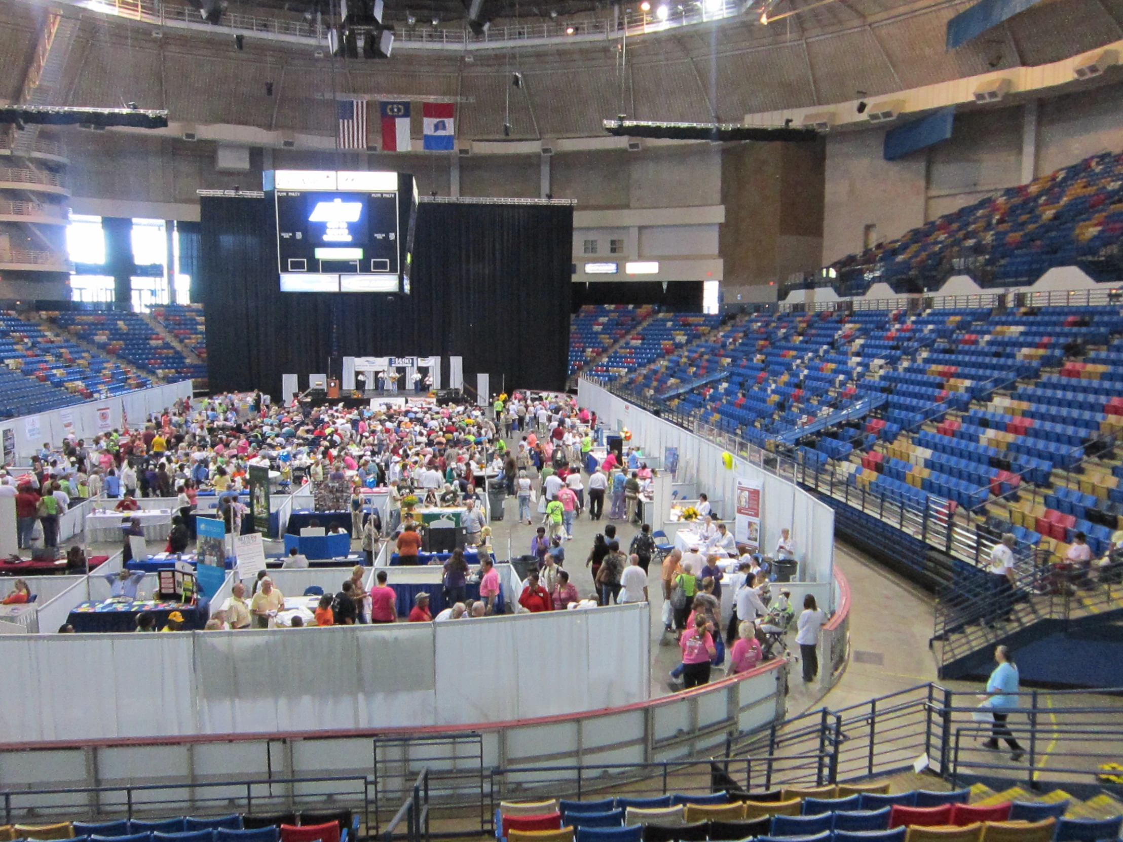 a crowd at an arena with people standing in the center