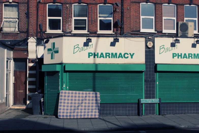 the front of a pharmacy on the corner of the street