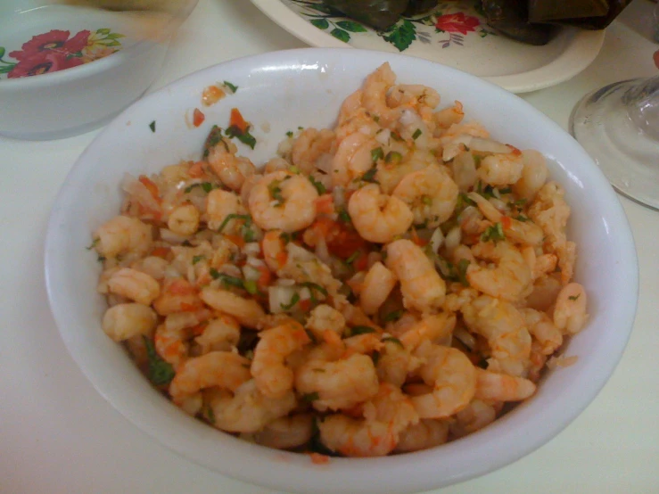 a plate topped with rice covered in shrimp