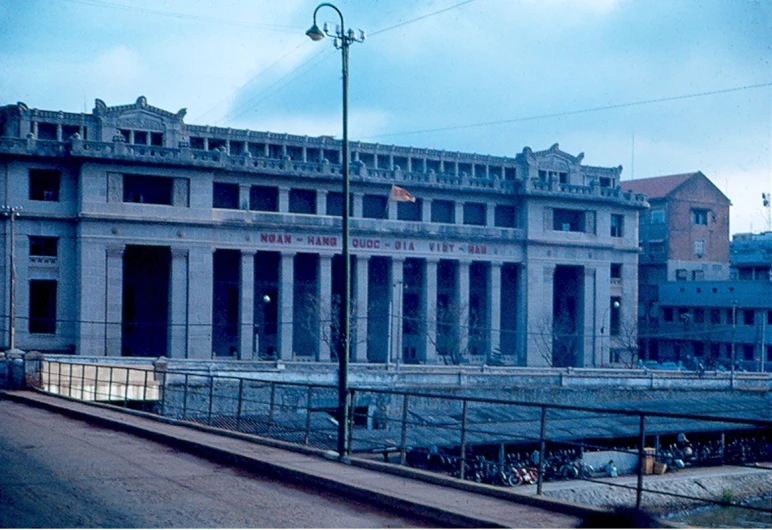 the facade of an old building with people walking in it