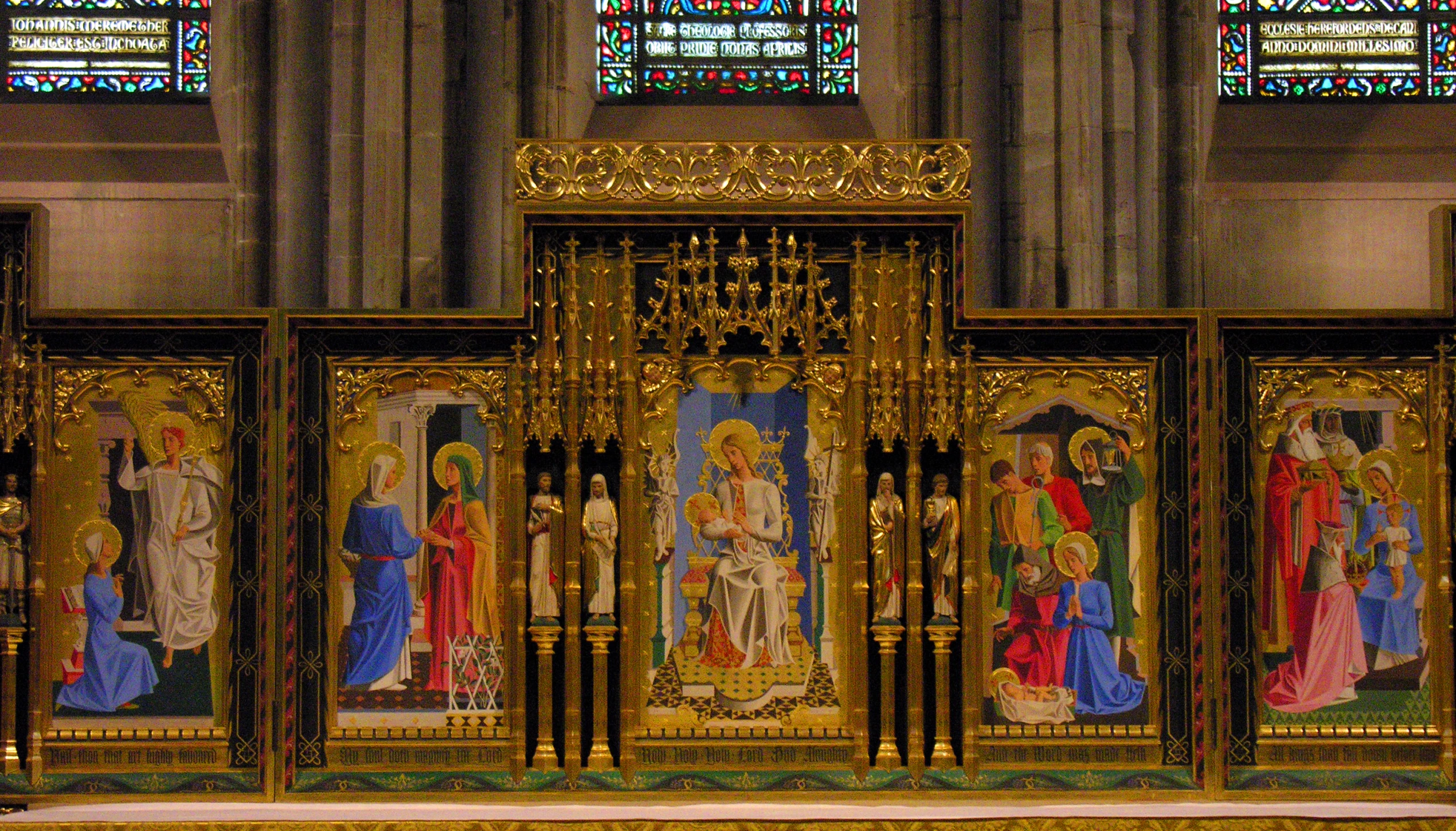 a gold and black altar with stained glass window behind