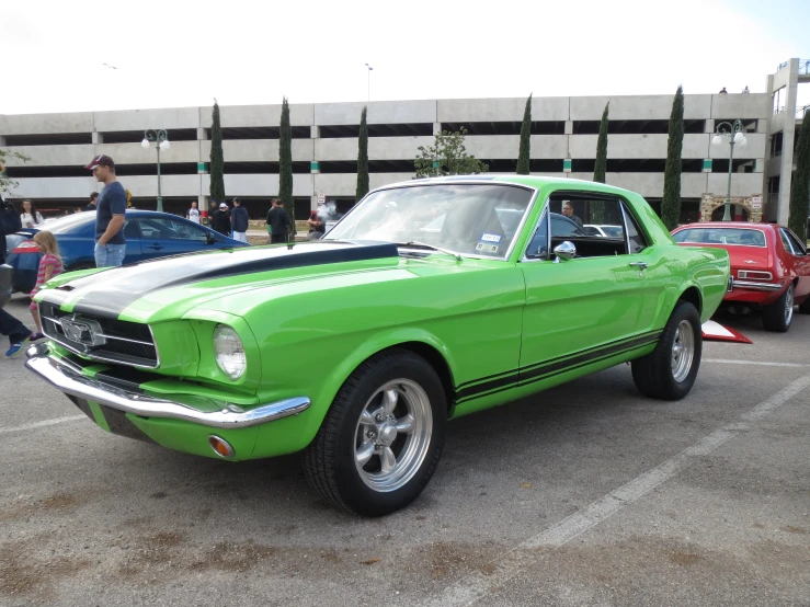 an old mustang sitting in a parking lot