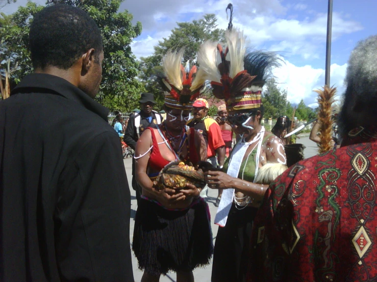 many people are dressed in colorful headdress and costumes