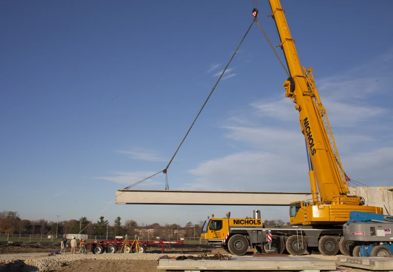 the crane is lifting the car over in the air