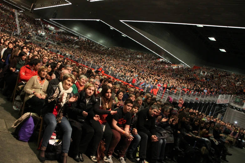 people in an audience watching and clapping