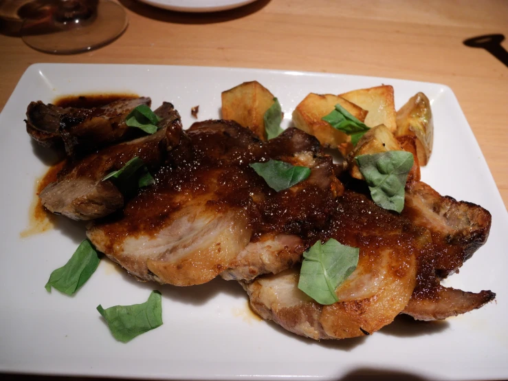 pork chops and potatoes with sauce on a plate