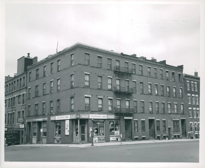 an old building with several floors on a corner in front